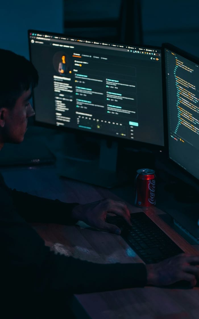 A developer working late at two monitors