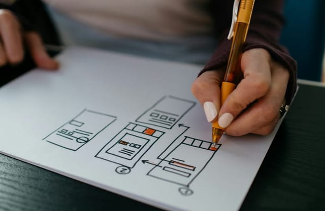 Designer sketching app wireframes on paper