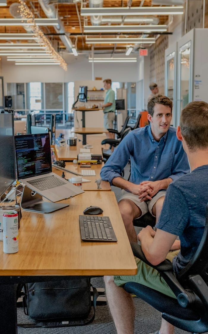A team talking through a project in an open-plan office